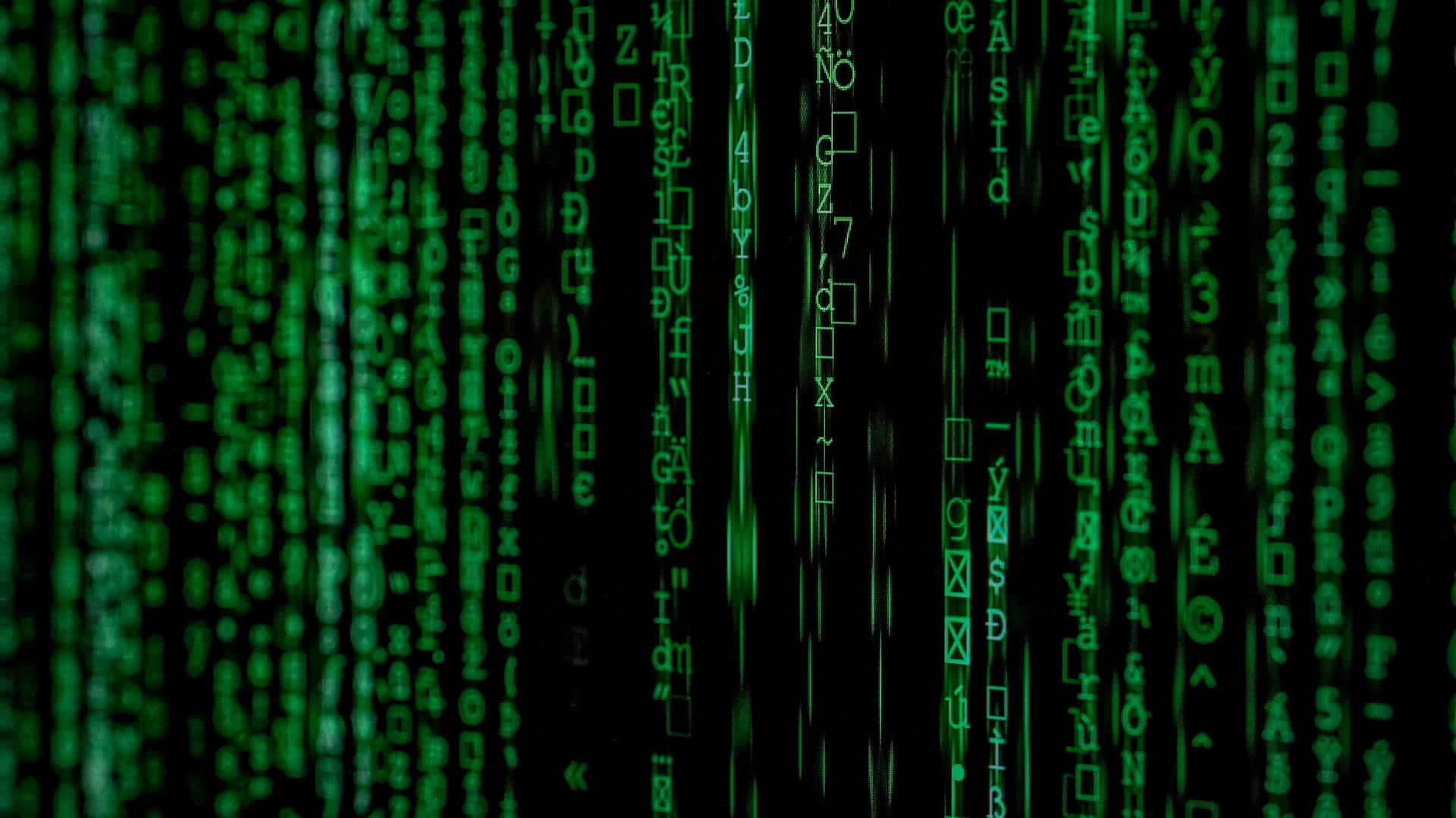 Streams of encrypted code cascading down a dark screen.