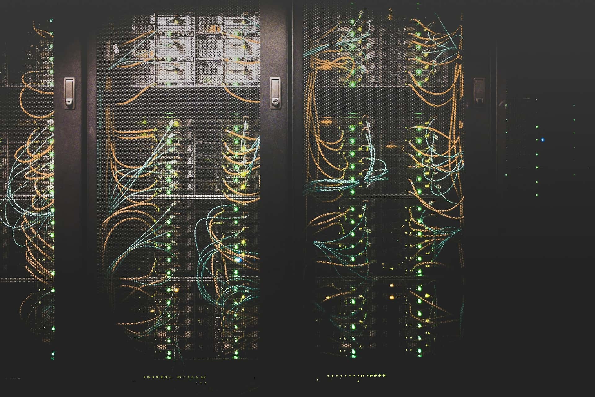 Dark server racks laced with patch cables and status lights.