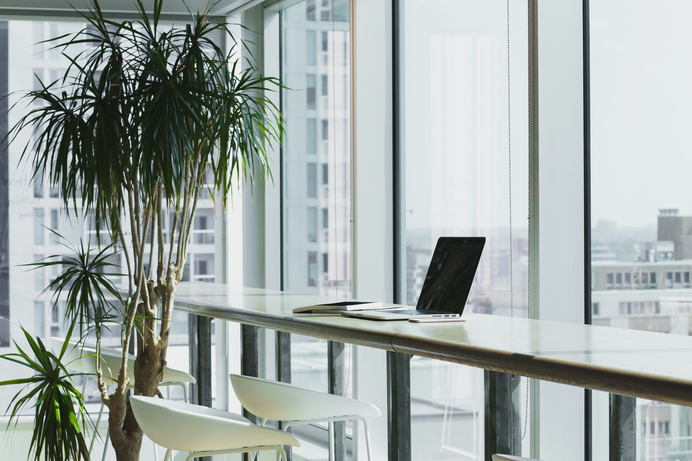 Stylized quiet workspace with a single glowing laptop.