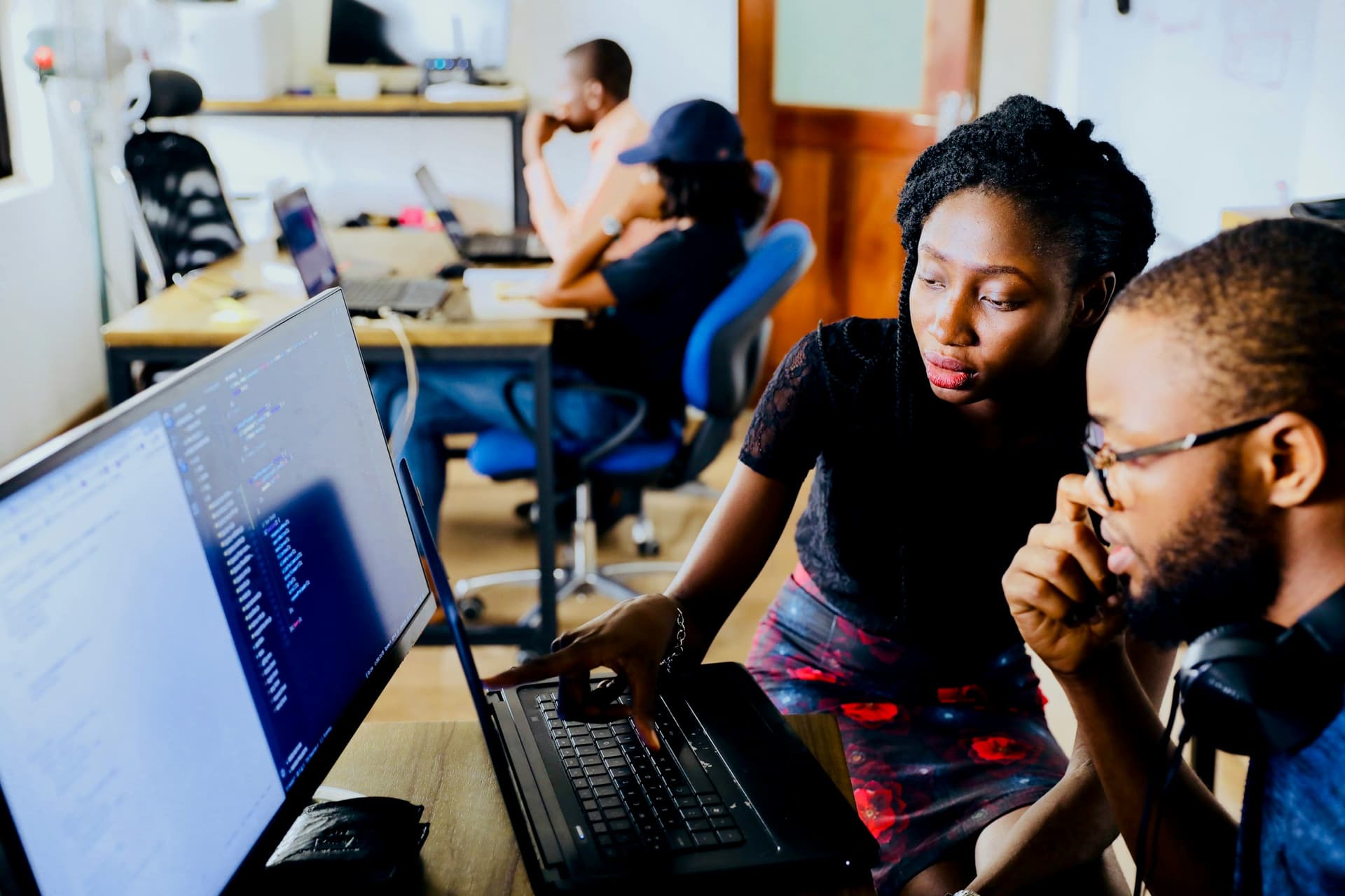 Two engineers pairing on a problem at one screen.