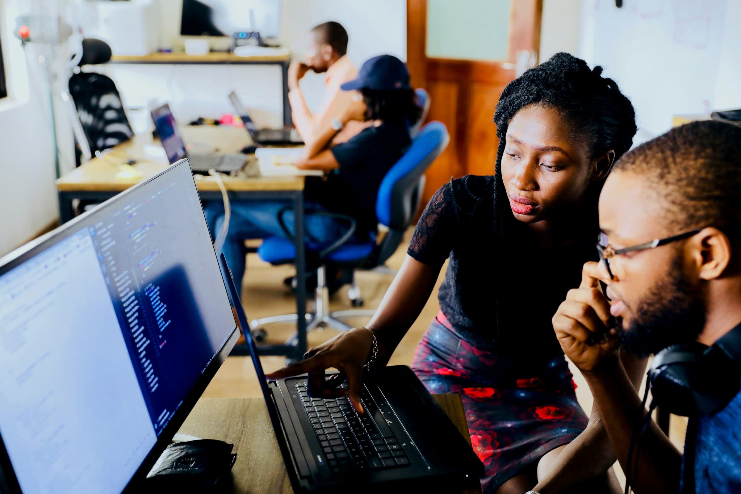 Two engineers pairing on a problem at one screen.