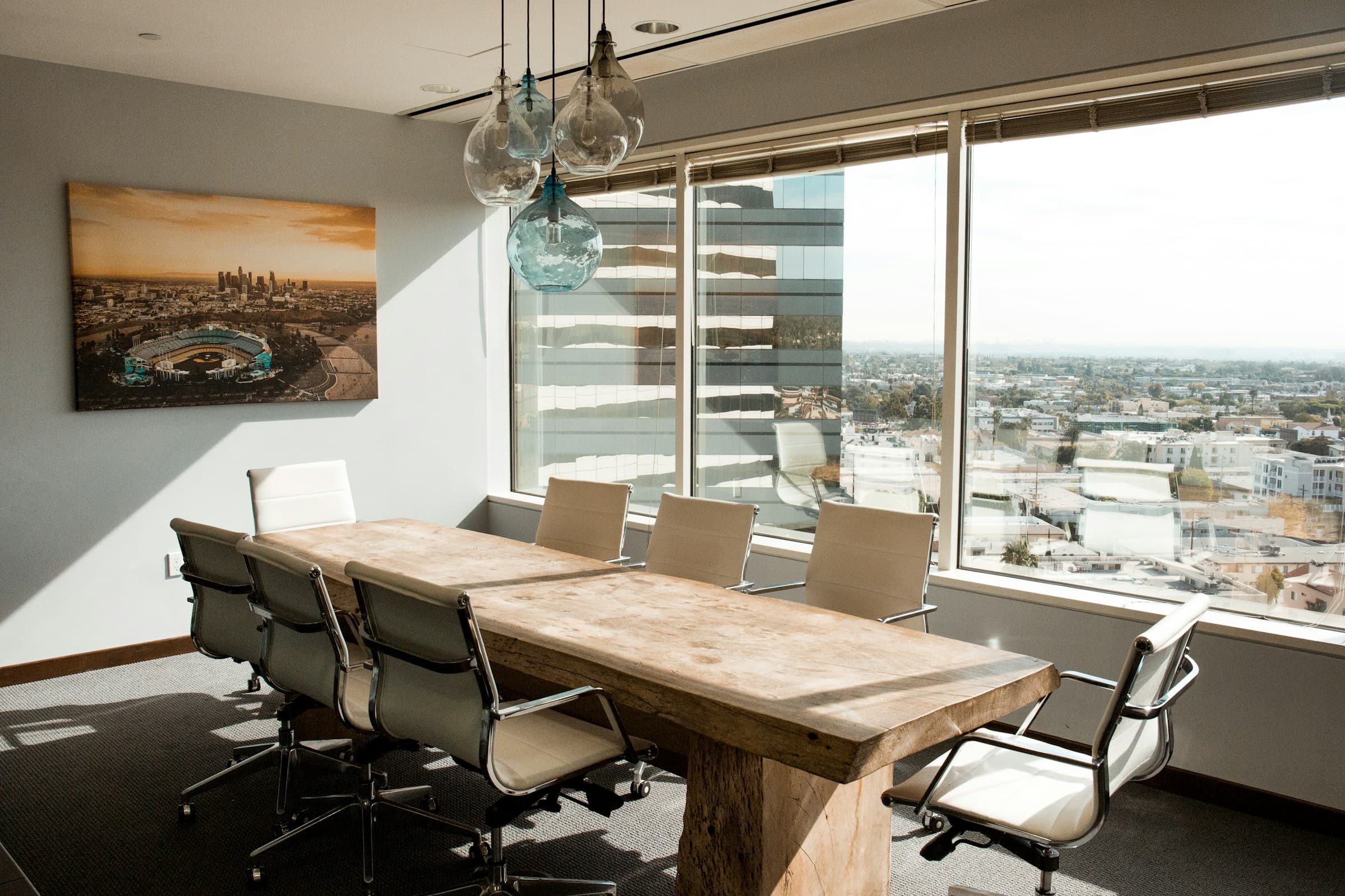 A bright conference room with a long meeting table.