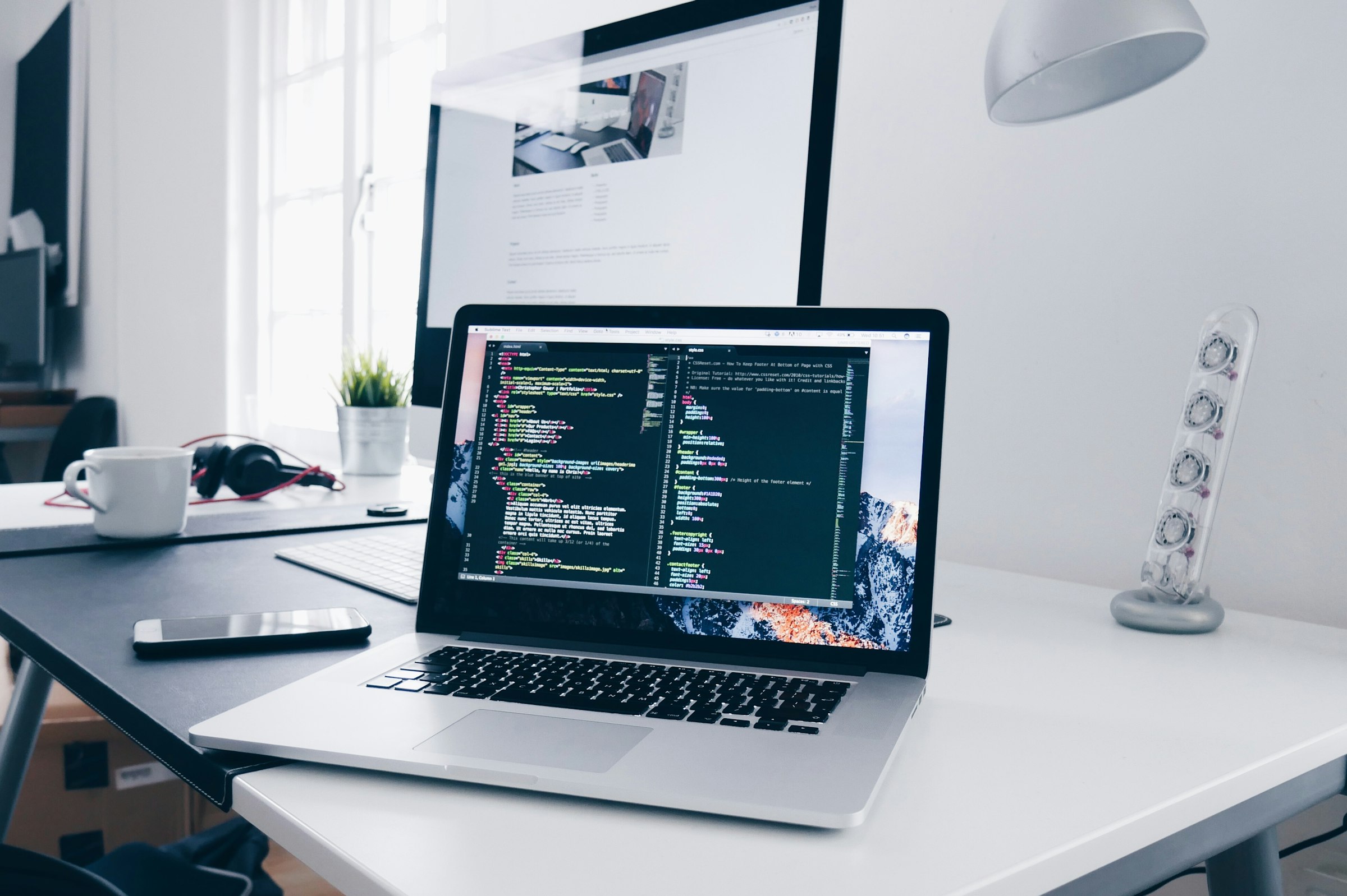 Source code open on a laptop in a dim workspace.