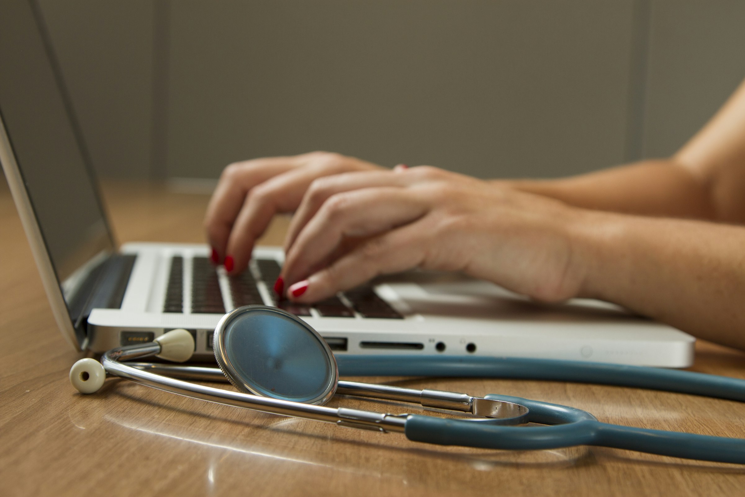 Stylized care-coordination interface with vitals and an ECG trace.
