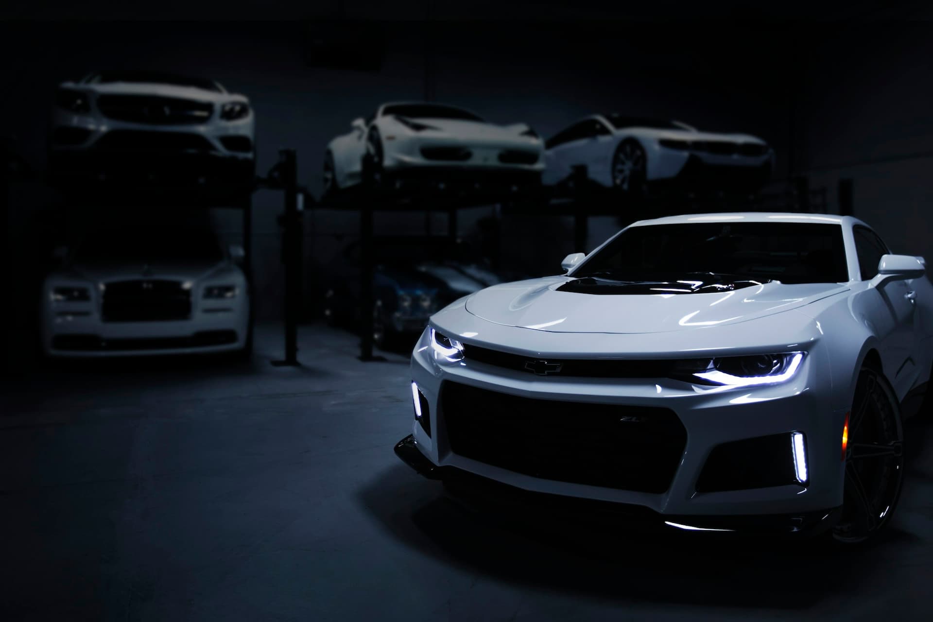 A modern sports car in a dark showroom.