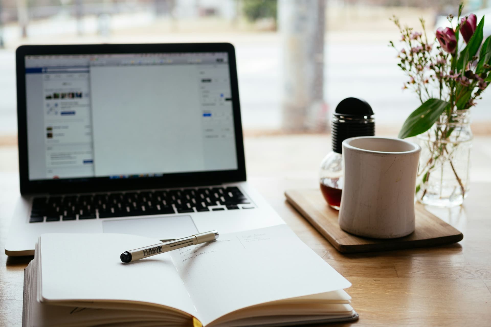A laptop and open notebook set up for studying.
