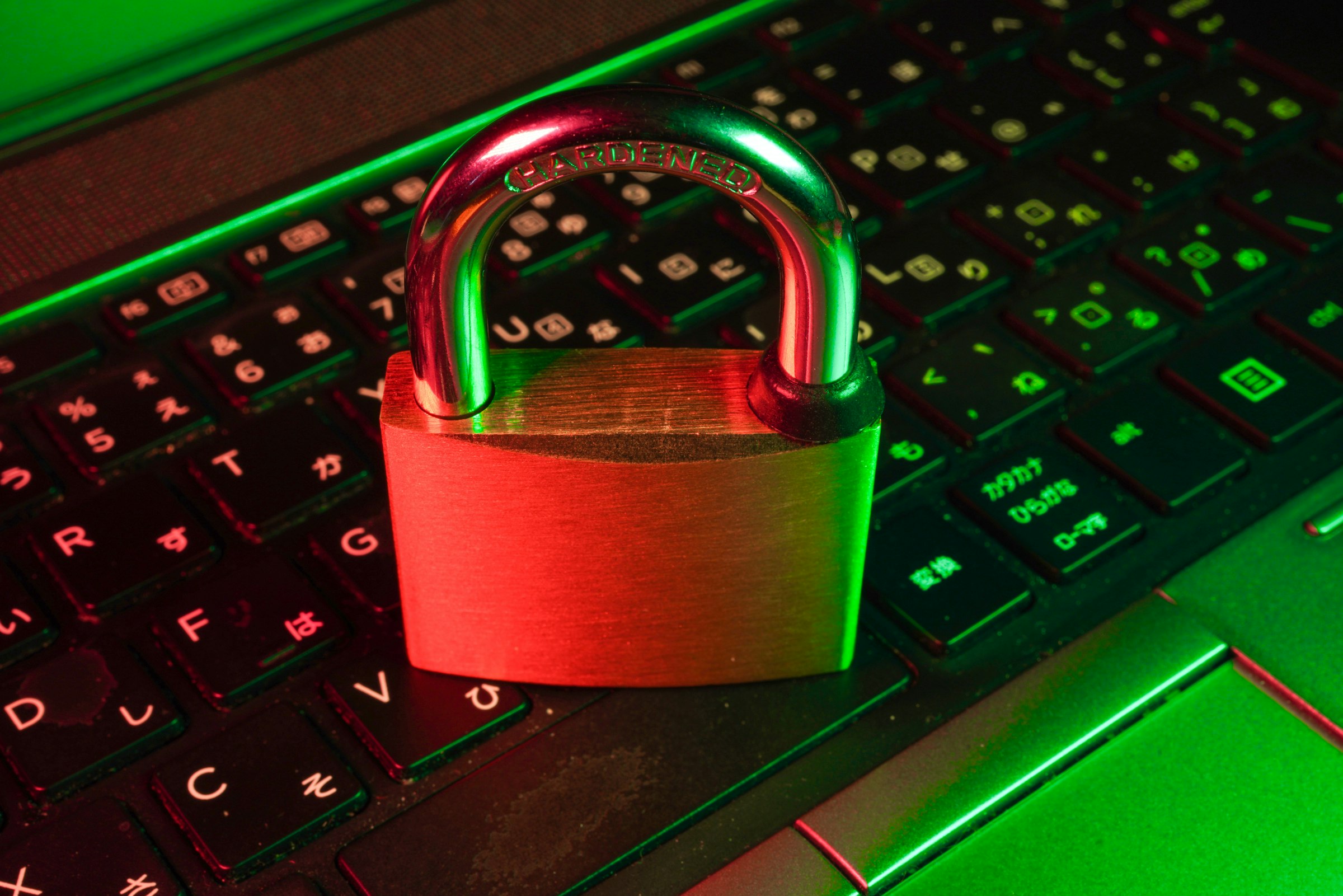 Stylized security shield with a padlock beside a passing security scan.