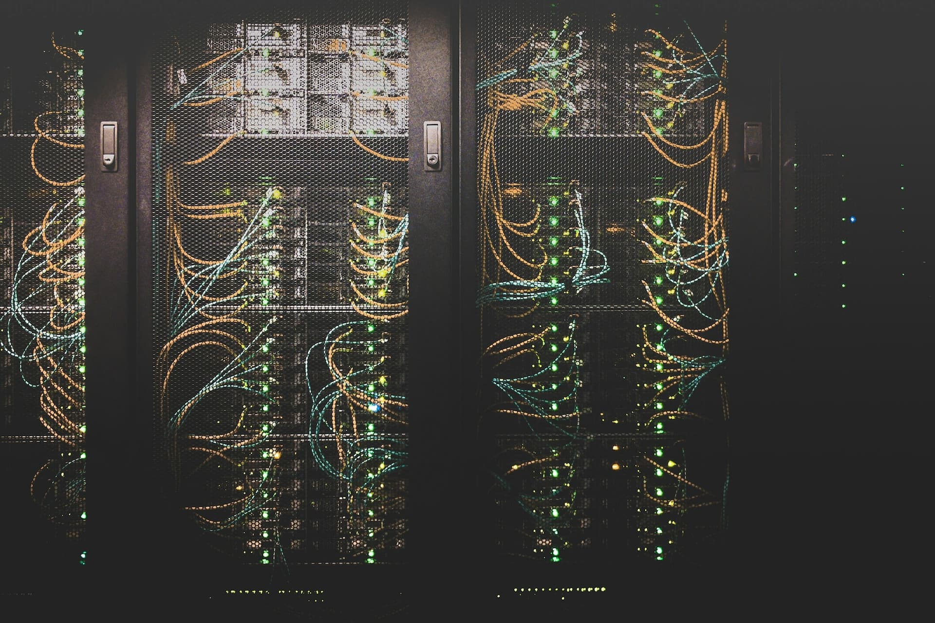 Dark server racks laced with patch cables and status lights.